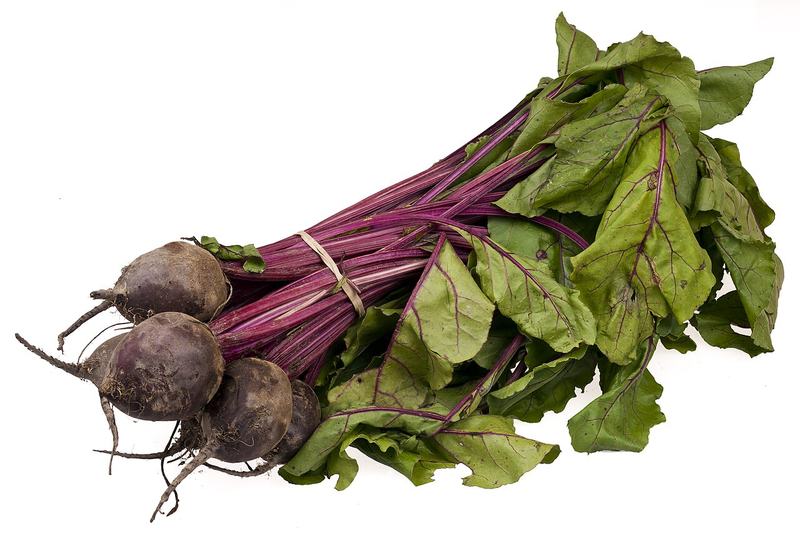 A bunch of beets with their leafy tops