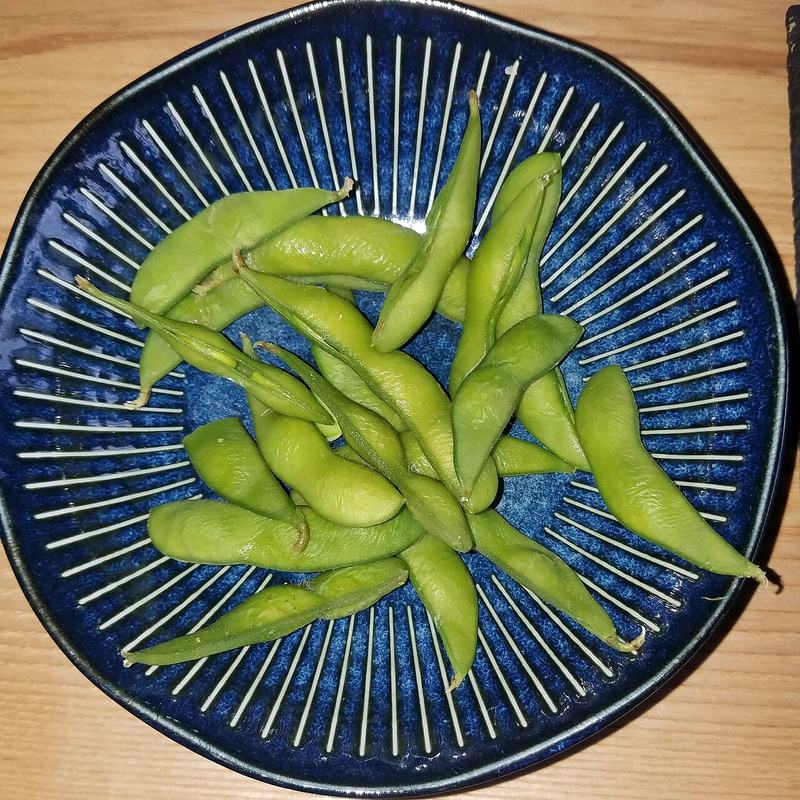 Green edamame pods on a plate