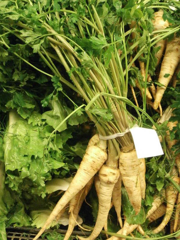 Parsnips, creamy white roots with their green tops